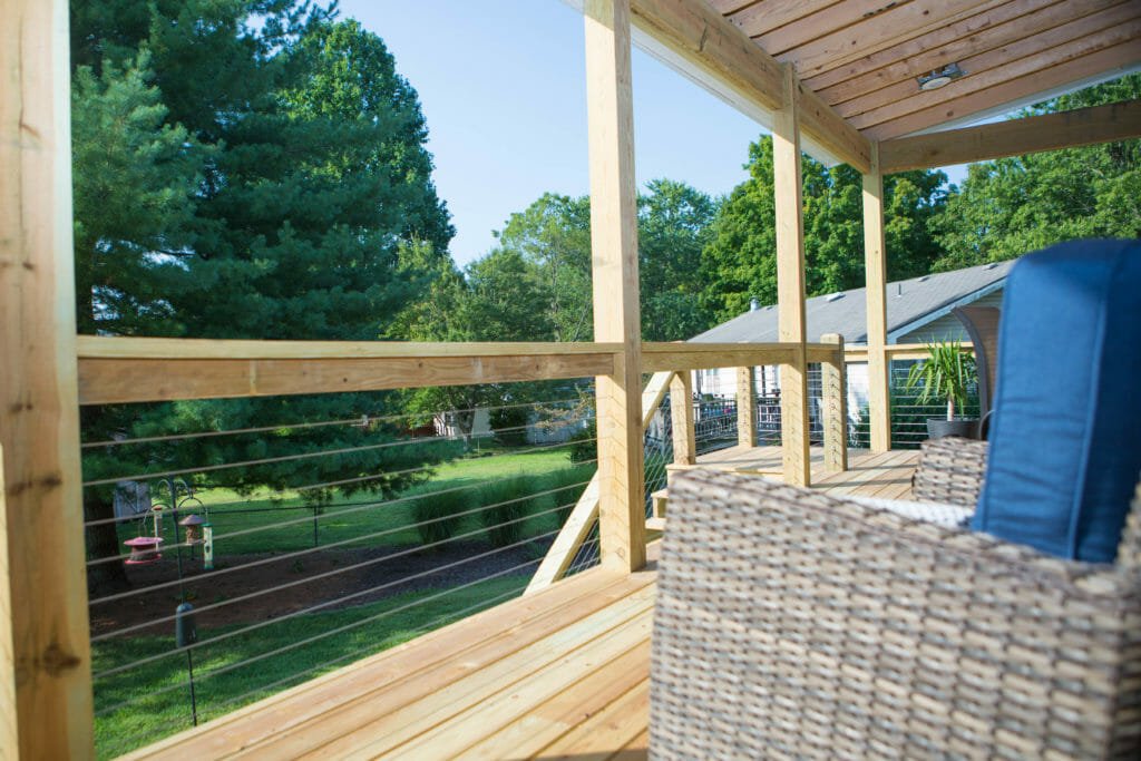 fenced in porch attached to a sunroom